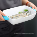 white ceramic bakeware with heat-resistant silicone handles
